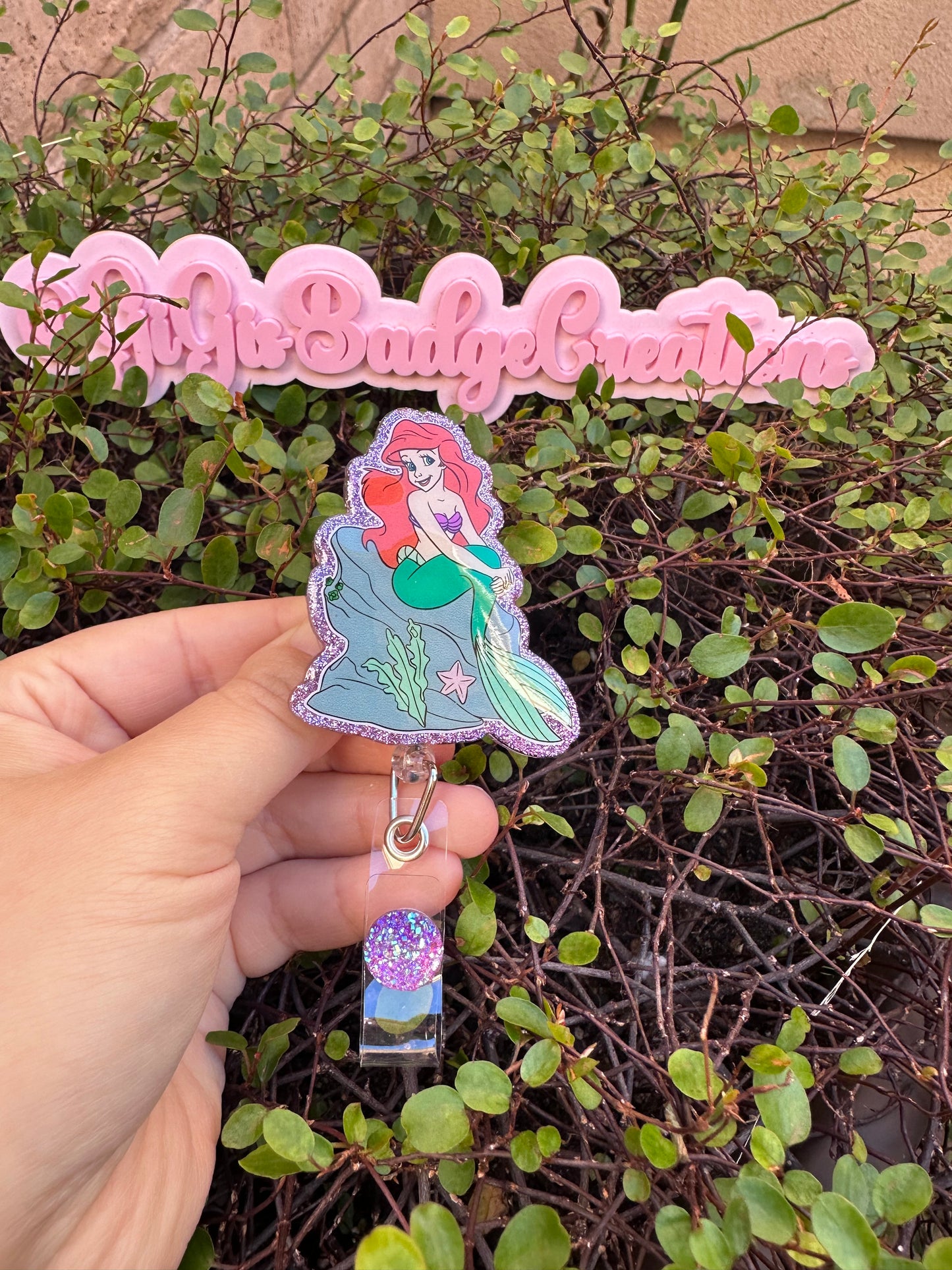 Ariel on a Rock Badge Reel